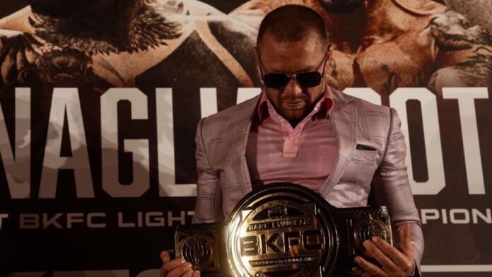 Conor McGregor holding the BKFC championship belt