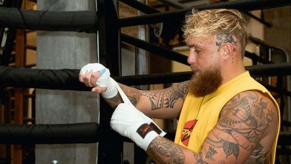 Jake Paul putting on boxing gloves
