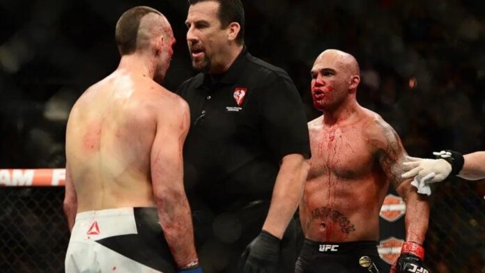John McCarthy holding Rory MacDonald against Robbie Lawler