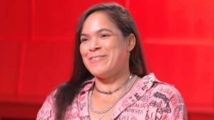 Amanda Nunes smiles during an interview in front of a red backdrop