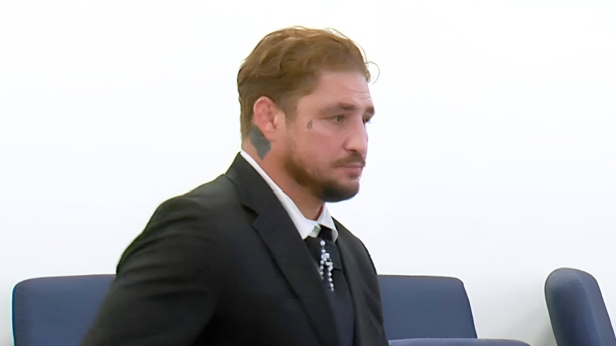 Diego Sanchez seated in a New Mexico courtroom wearing a dark suit