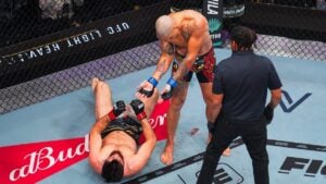 Alex Pereira stands over a downed Magomed Ankalaev after his first-round TKO win at UFC 320