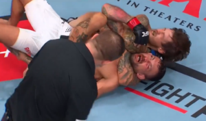Steven Koslow locks in a rear-naked choke on Chad Anheliger as the referee watches at UFC Edmonton