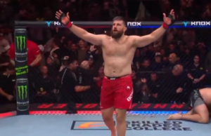 Tanner Boser raises his arms in celebration in the Octagon after his TKO win over Jhonata Diniz at UFC Edmonton