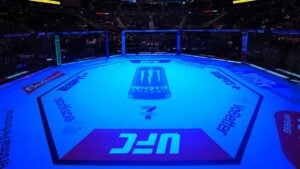 Empty UFC Octagon under blue arena lighting before a UFC event